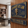 A decorative attorney-at-law wall sign in a navy blue and gold finish hangs on a wood-paneled wall in a modern office setting. The sign features ornate gold detailing, a blindfolded lawyer bust, and text including 'ATTORNEY AT LAW' and 'YOUR LAWER IS YOUR FRIEND'.