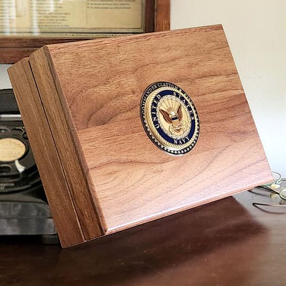 side view of navy keepsake box with medallion and engraving