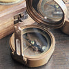 Solid brass working military compass shown open with floating compass needle and mirrored top