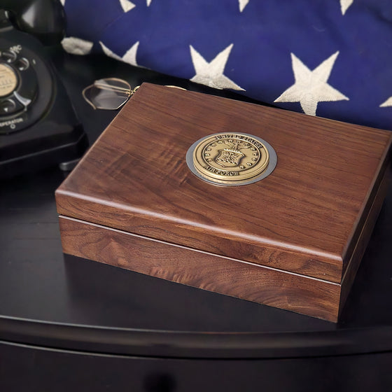 Walnut keepsake box with brass US Air Force medallion surrounded by engraved rim