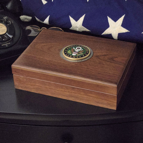 Walnut keepsake box with engraved pewter Army medallion on an end table