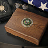 Walnut keepsake box with engraved pewter Army medallion on an end table